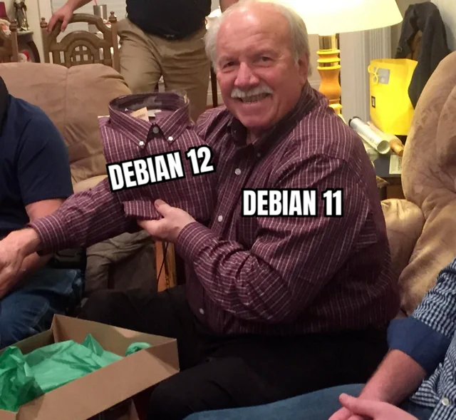 An elderly man smiling, holding a folded shirt gifted to him, which exactly matches the one he's wearing. The new shirt is labelled DEBIAN 12 while his current shirt is labelled DEBIAN 11