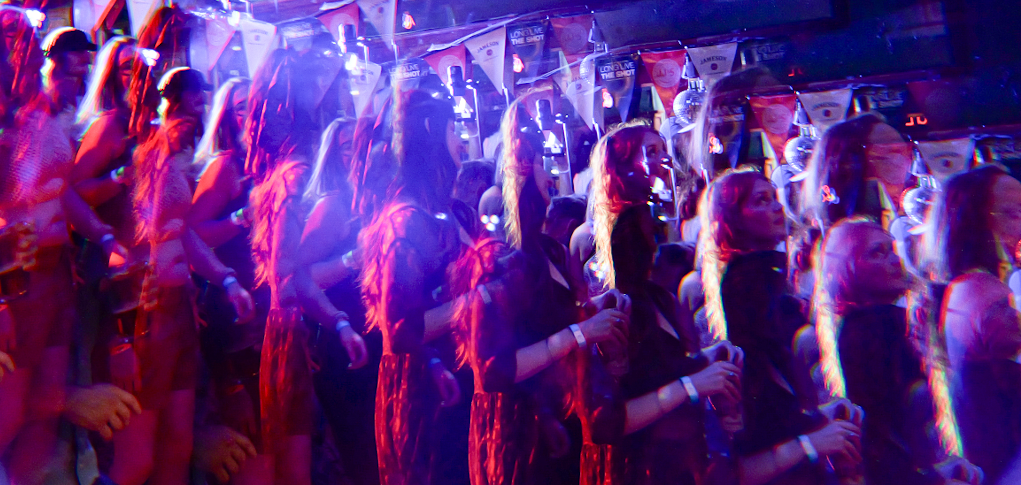 A set of images showing a crowd dancing under blue, pink, and purple stage lights. 