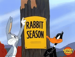 daffy duck and bugs bunny tear off subsequent signs reading rabbit season and duck season in sequence